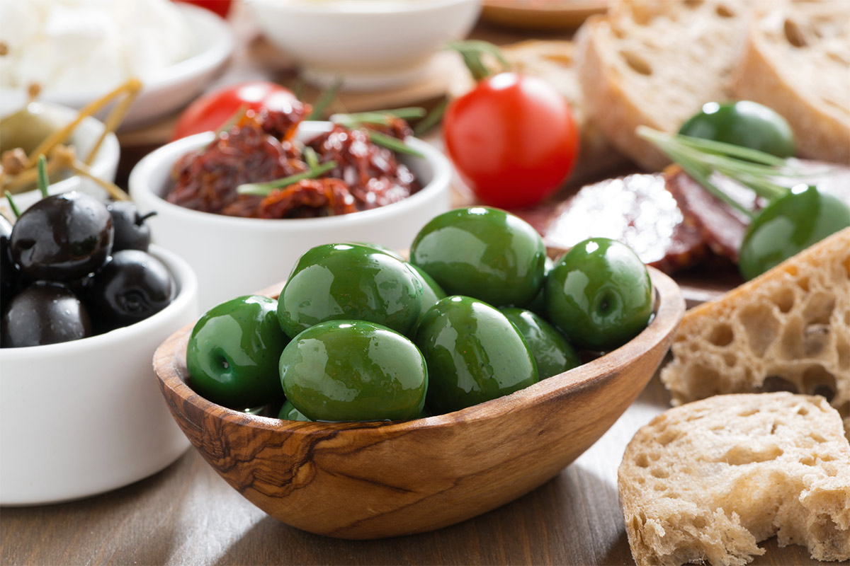 Assorted appetizers like green and black olives, cherry tomatoes, sun-dried tomatoes, bread etc. | Girl Meets Food