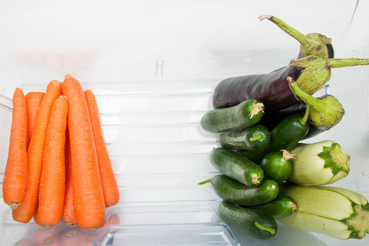 Several carrots, zucchinis, cucumbers and eggplants are in the fridge | Girl Meets Food