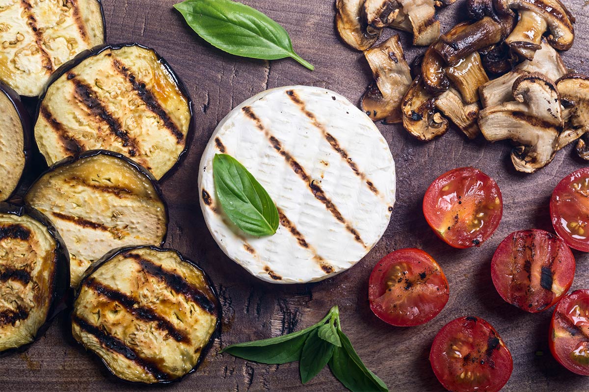 Grilled brie with vegetables on a wooden board | Girl Meets Food