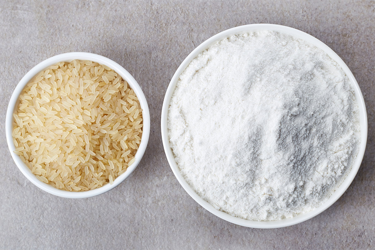A bowl of rice and a bowl of rice flour stand on a grey surface | Girl Meets Food