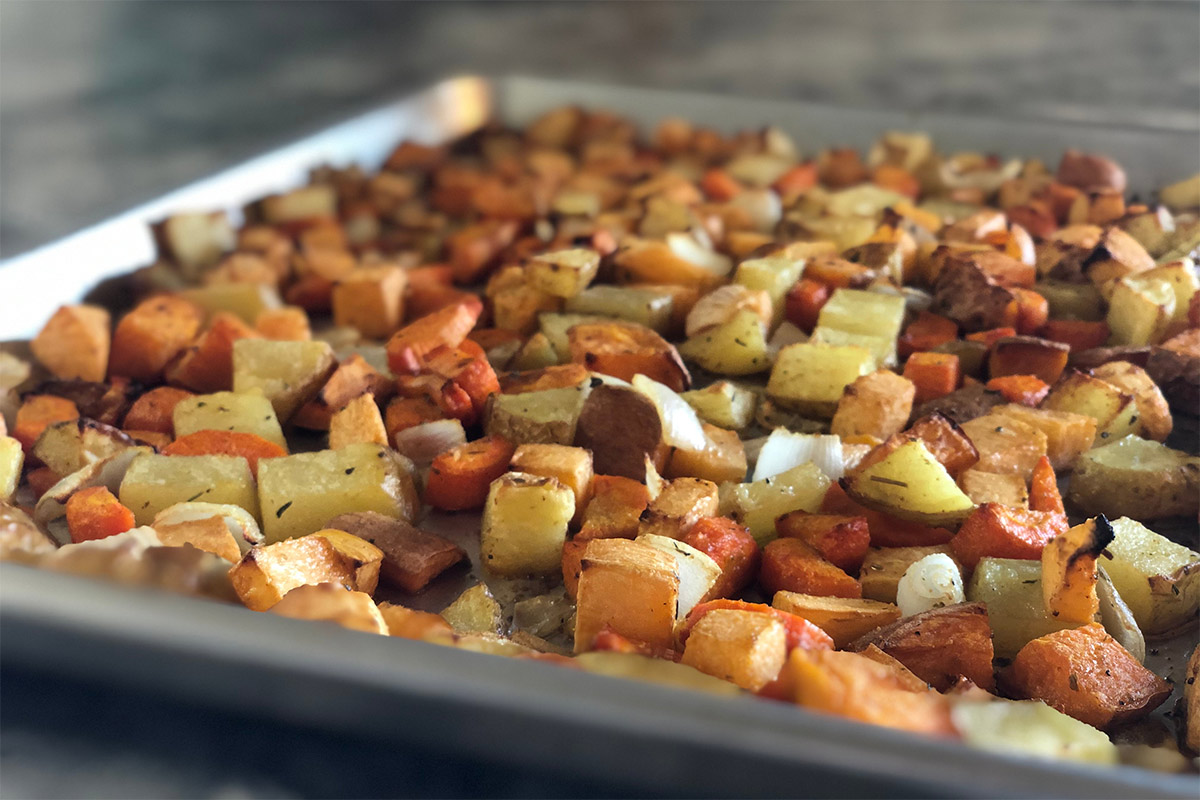Baked rutabaga and other vegetables are on the baking sheet | Girl Meets Food