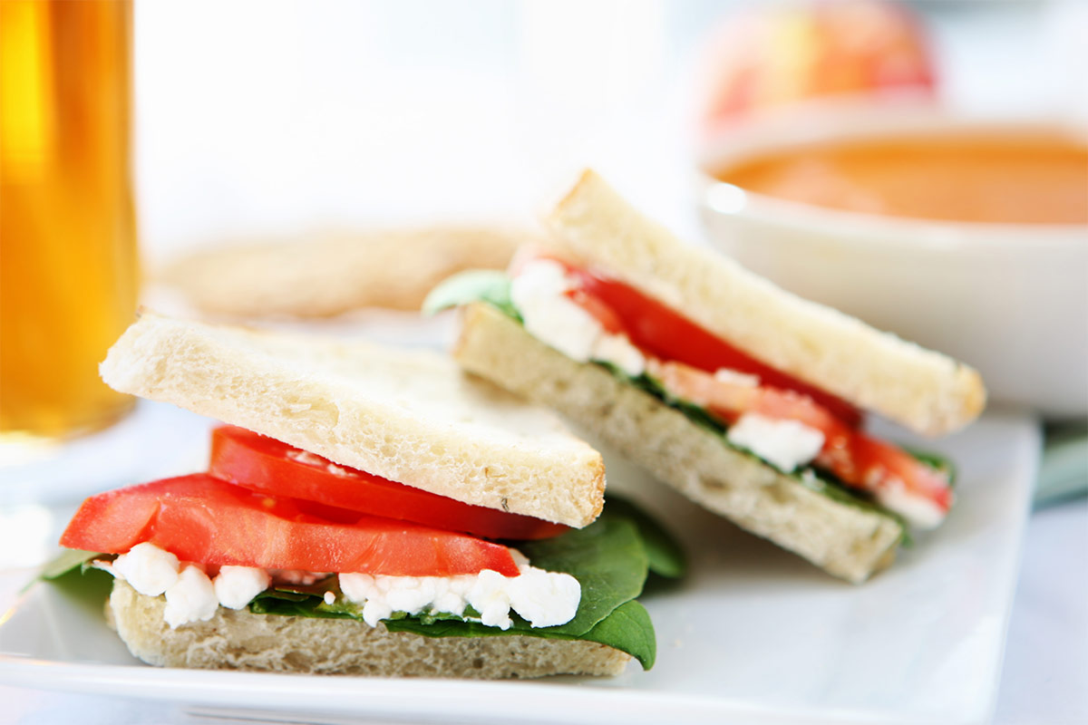 A plate with two sandwiches, and a bowl of soup next to it | Girl Meets Food