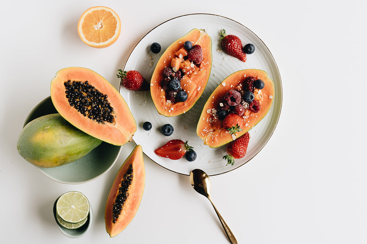 Sliced Papaya with berries on top close up | Girl Meets Food