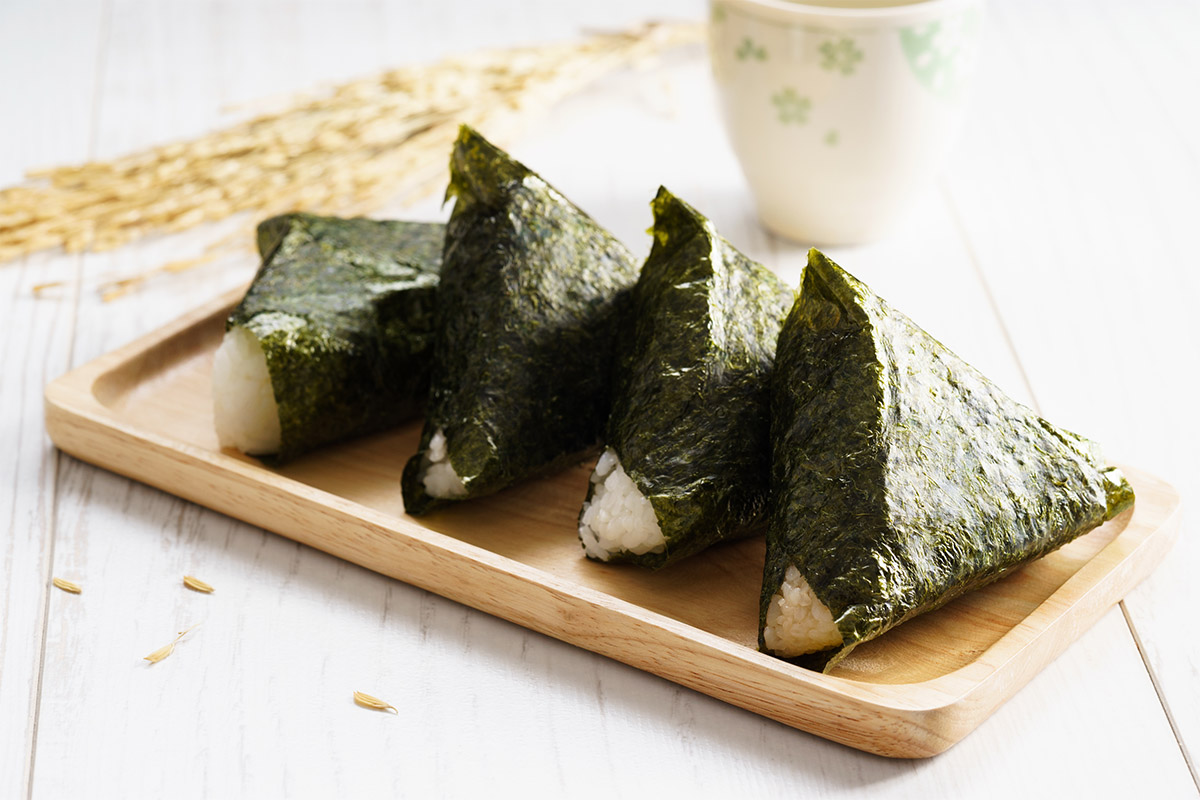 Onigiri on a wooden rectangle dish | Girl Meets Food