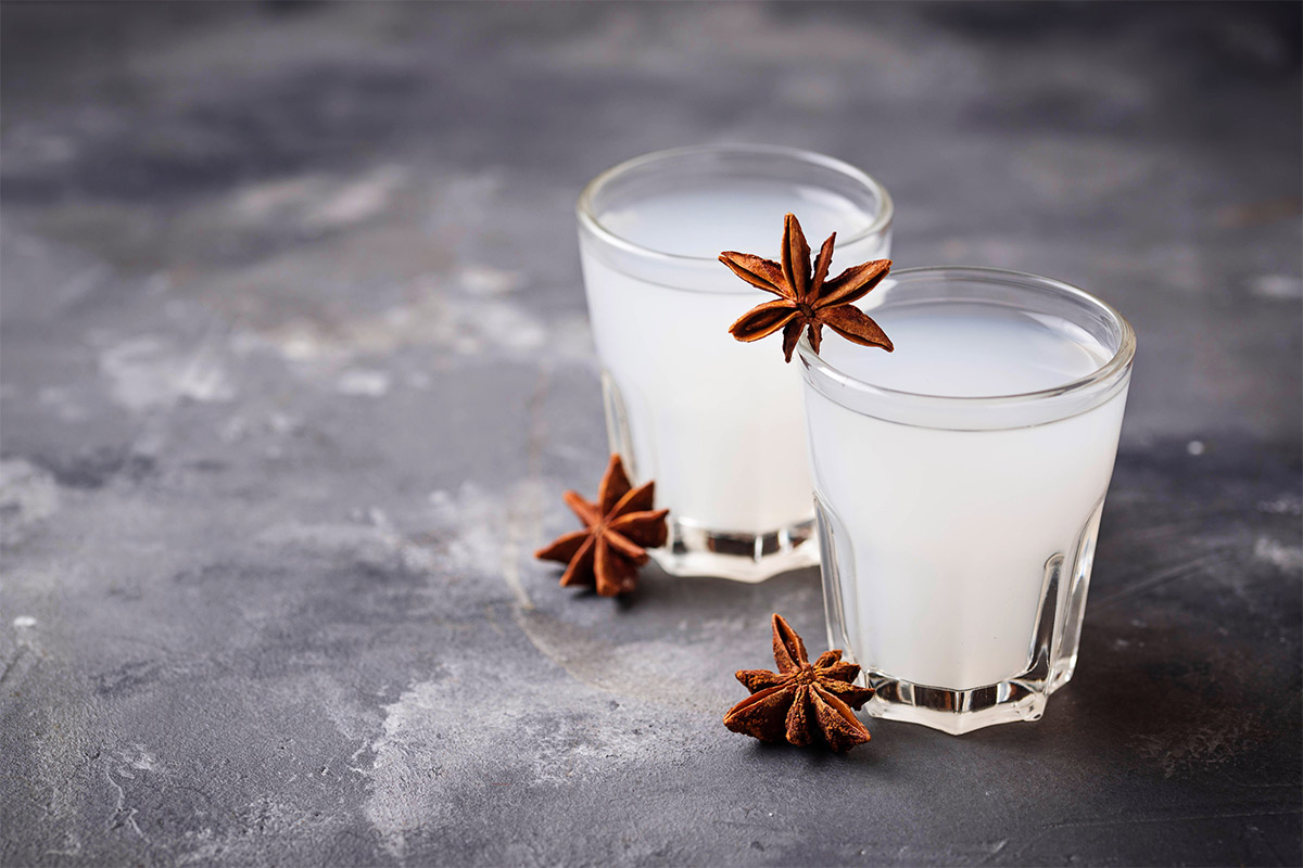 Two glasses of ouzo and anise on a grey surface | Girl Meets Food