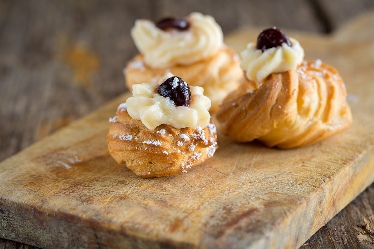Three zeppole cakes on a board | Girl Meets Food