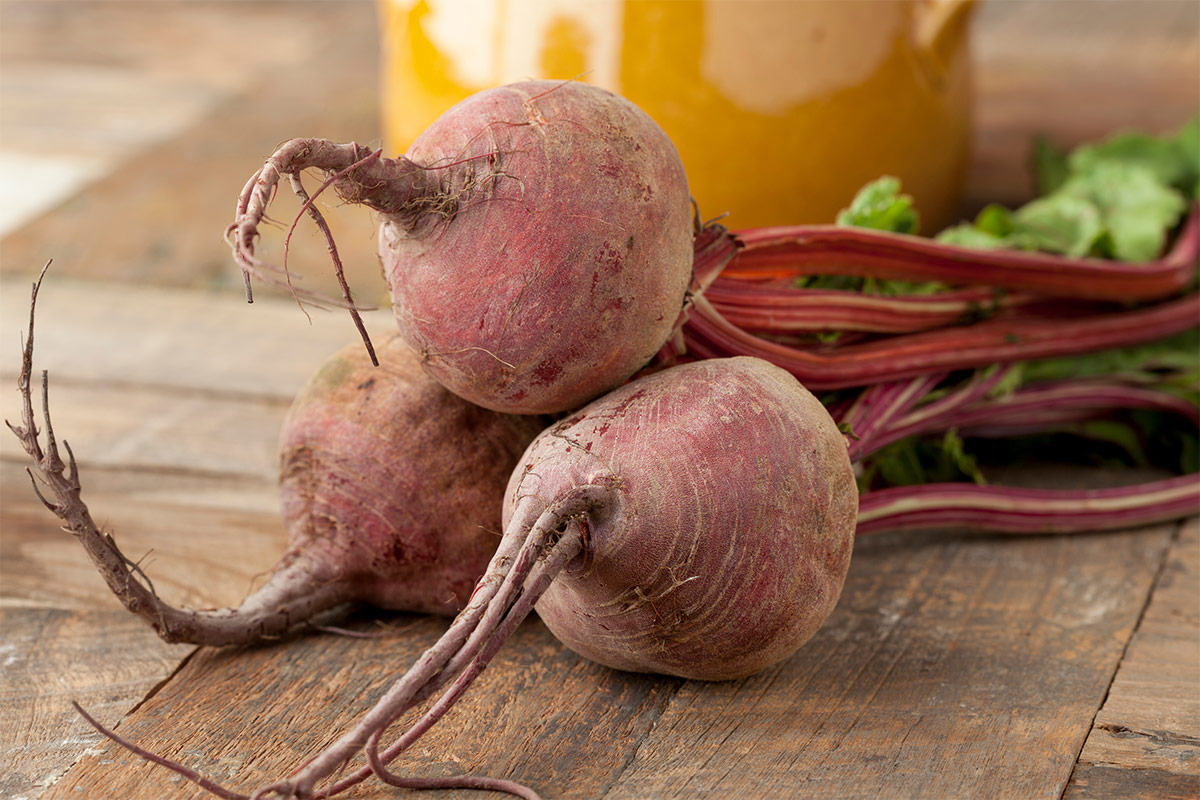 Raw beetroots on wooden surface | Girl Meets Food