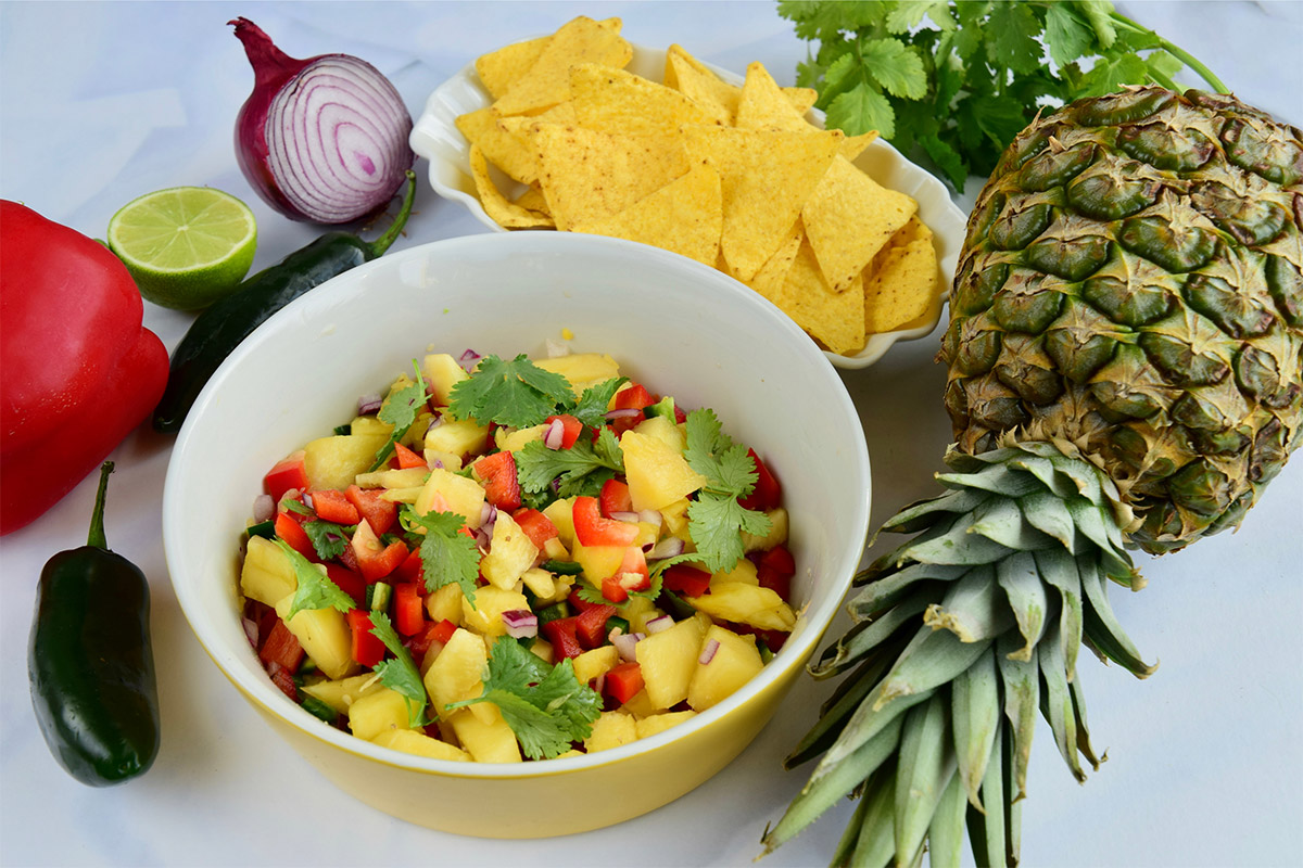 A bowl of pineapple salsa with tortilla chips | Girl Meets Food