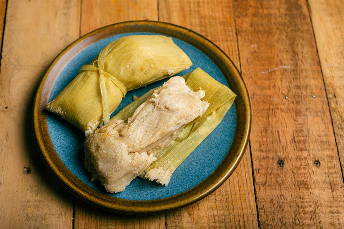 Tamales de Elote on a wooden table | Girl Meets Food