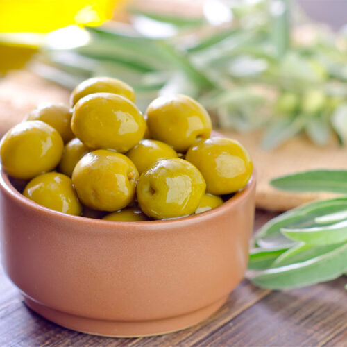 Green olives in a small bowl | Girl Meets Food