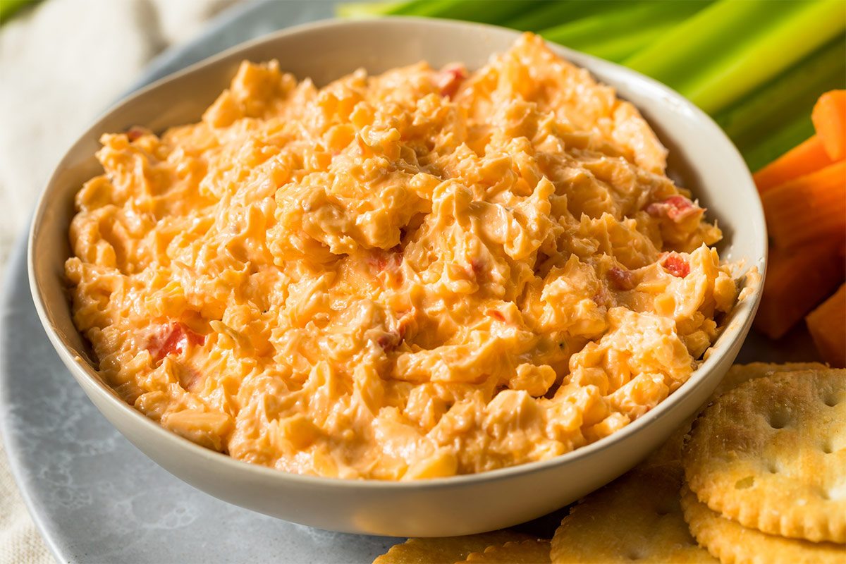 Crackers and veggies are next to the bowl of pimento cheese | Girl Meets Food