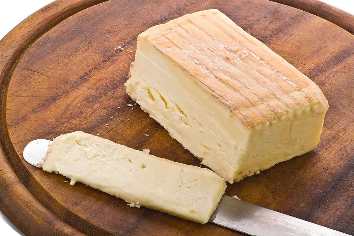 Taleggio cheese on a cutting board | Girl Meets Food