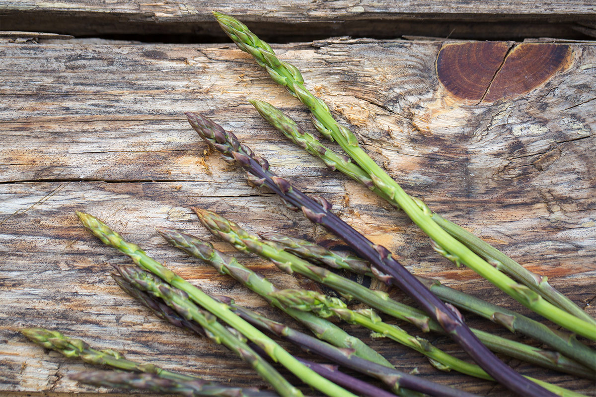 Wild asparagus stems on the wooden surface | Girl Meets Food
