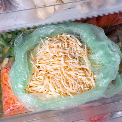 A packet of frozen grated cheese in the freezer | Girl Meets Food