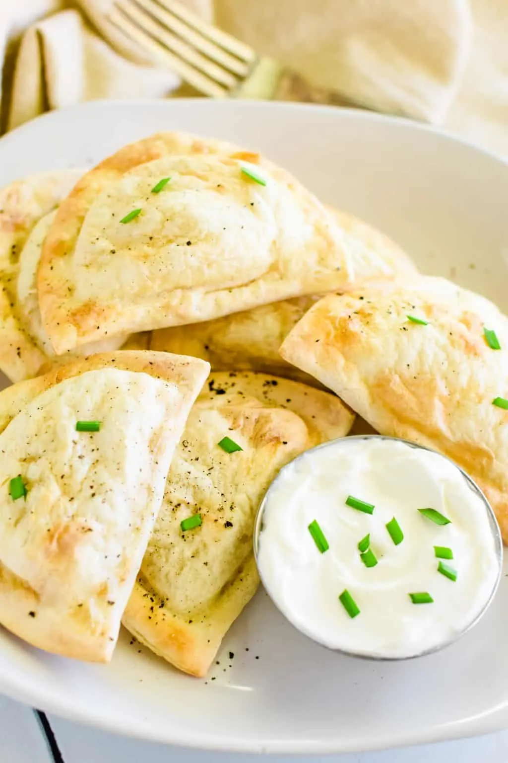 Air fryer frozen pierogies served with sauce on a plate | Girl Meets Food