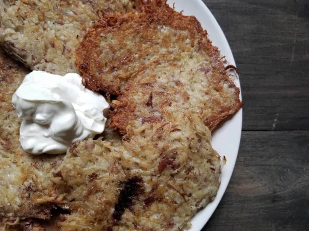 Potato pancakes topped with sour cream | Girl Meets Food