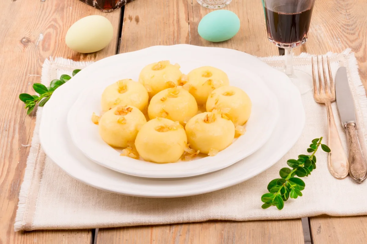 A plate of Kluski Śląskie (Silesian Dumplings) on the table | Girl Meets Food