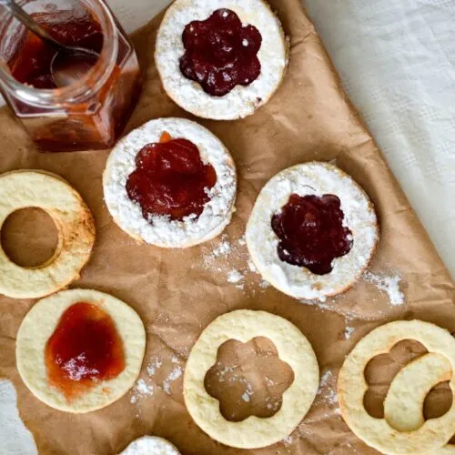 Maslenki (Bulgarian Christmas jam-filled cookies) on a piece of paper that is on the table | Girl Meets Food