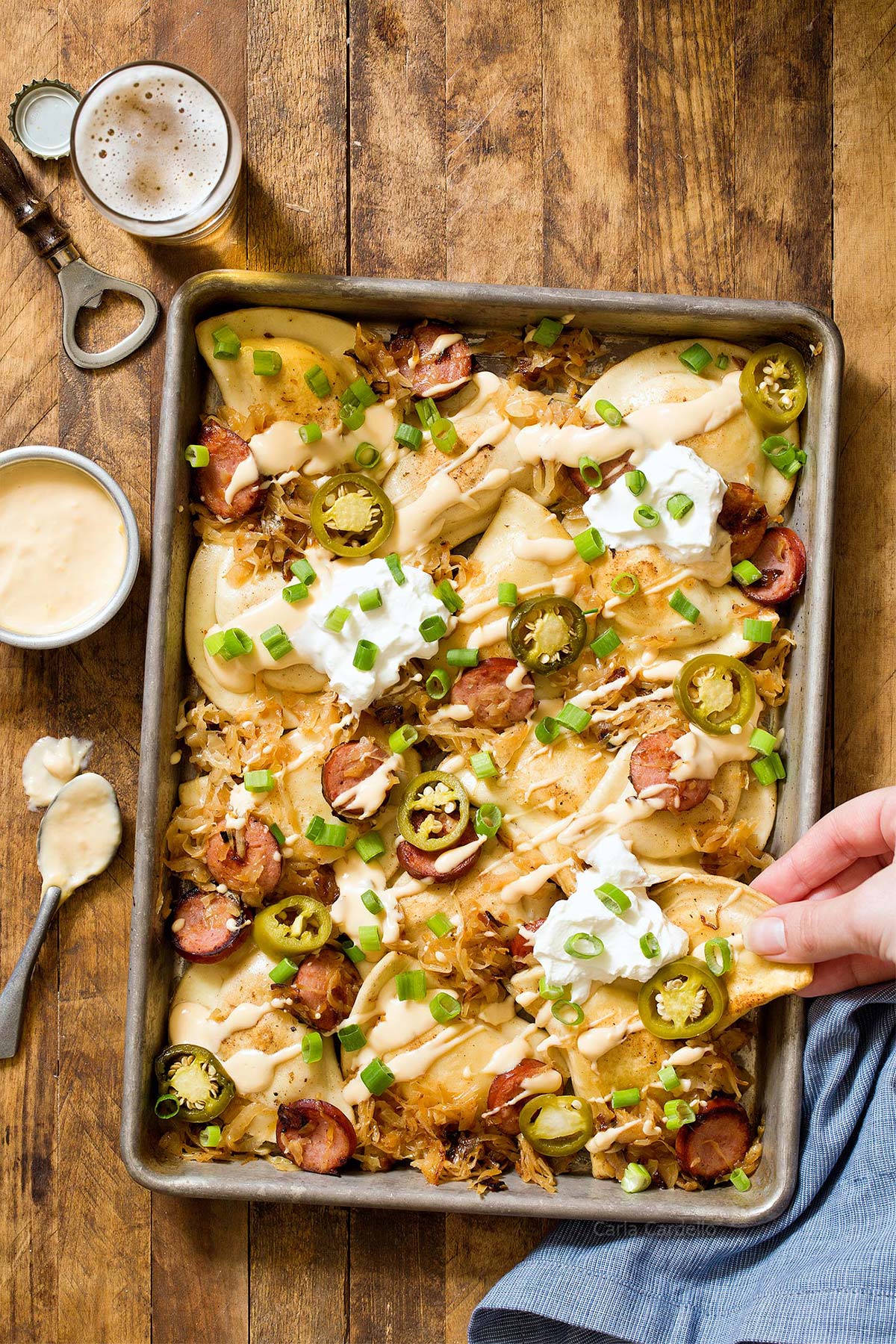A baking tray with Pierogy Nachos on a table | Girl Meets Food