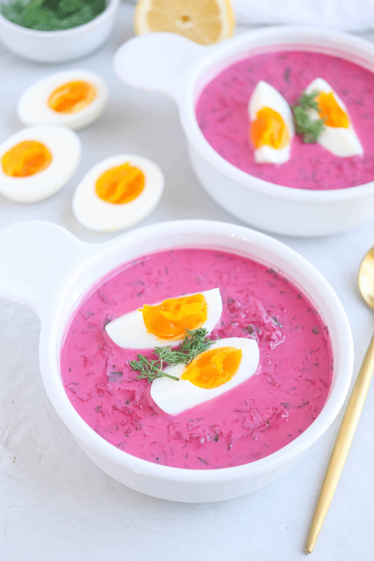 Two bowls of Polish cold beet soup (Chłodnik) on the table | Girl Meets Food