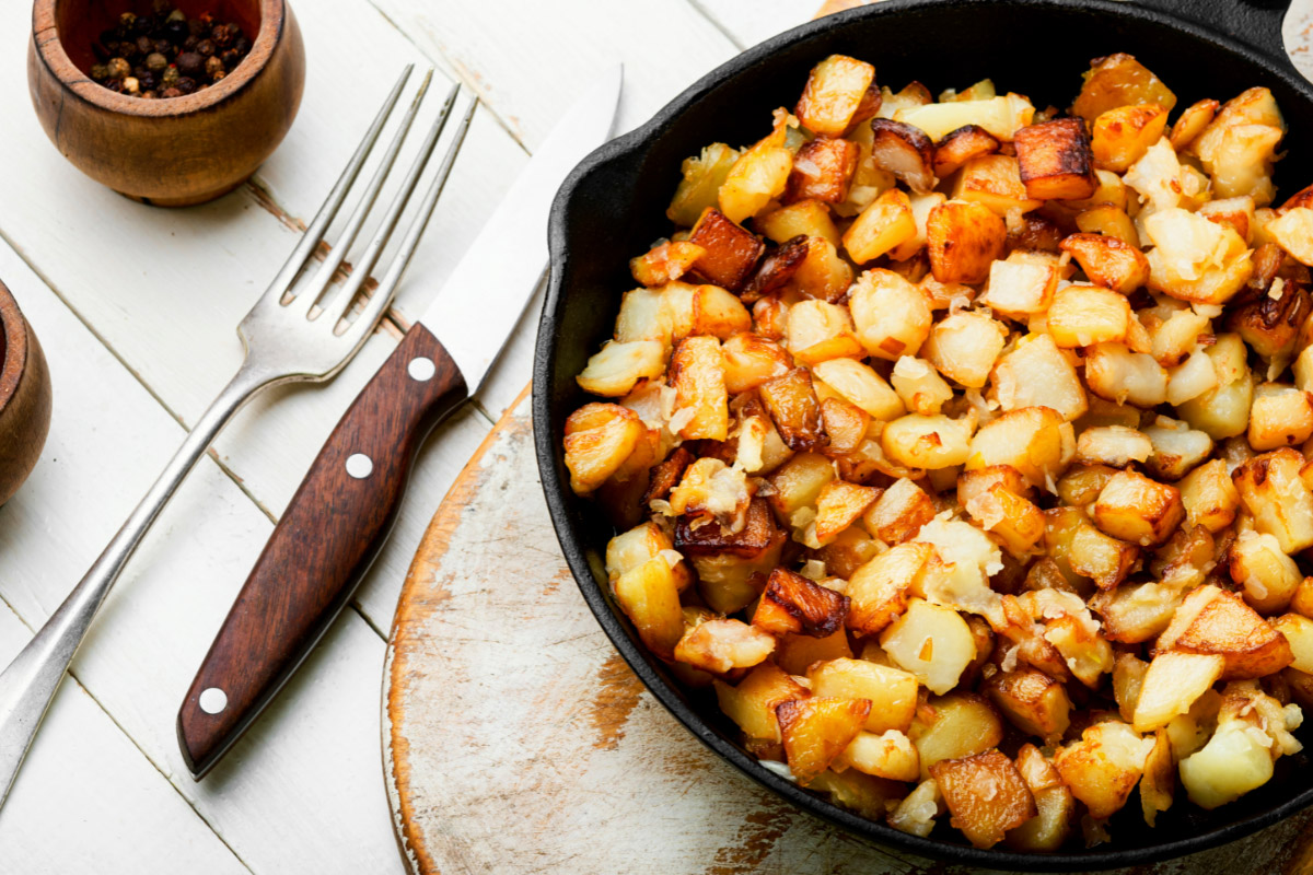 Skillet breakfast potatoes on the cutting board | Girl Meets Food