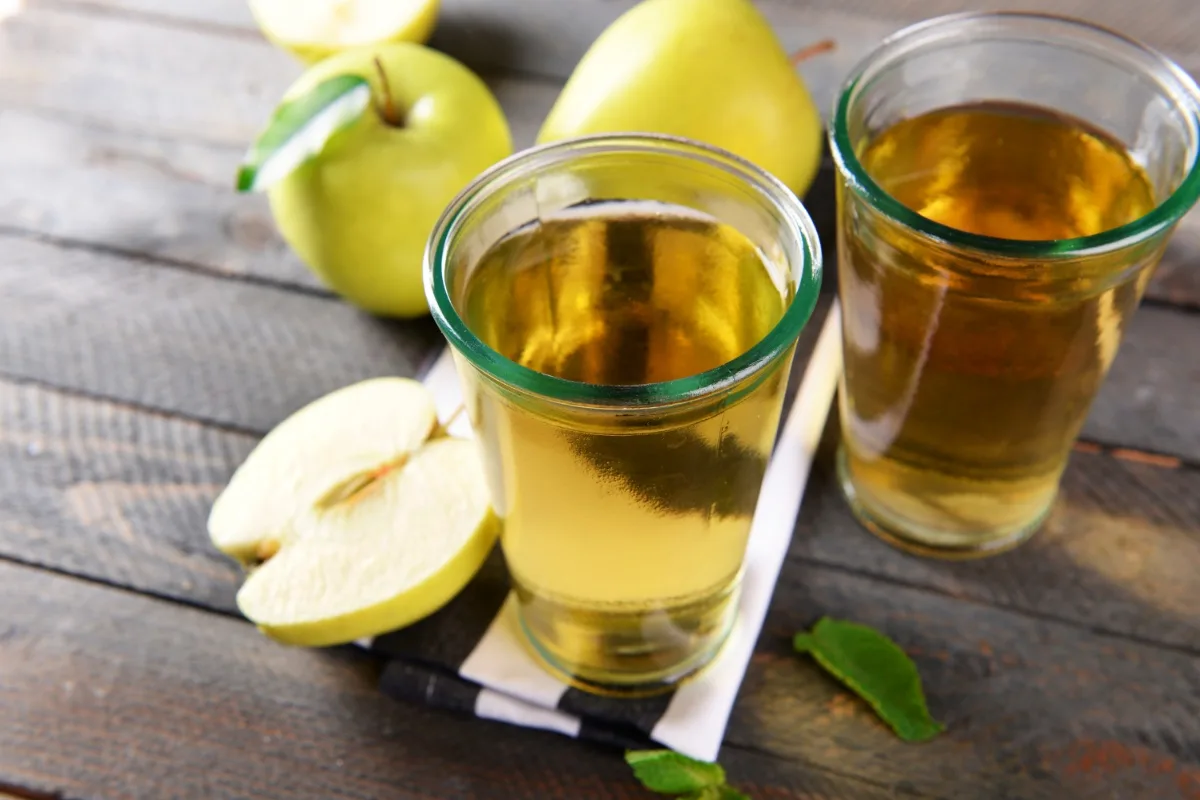 Two glasses of apple juice with apples on the table | Girl Meets Food