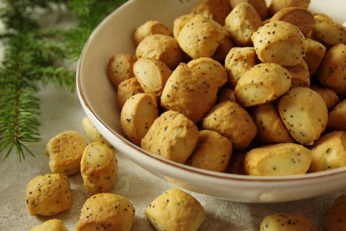 A bowl of Kūčiukai cookies on a festive table | Girl Meets Food