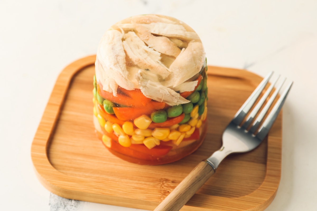 Nóżki w Galarecie on a cutting board with a fork next to it | Girl Meets Food