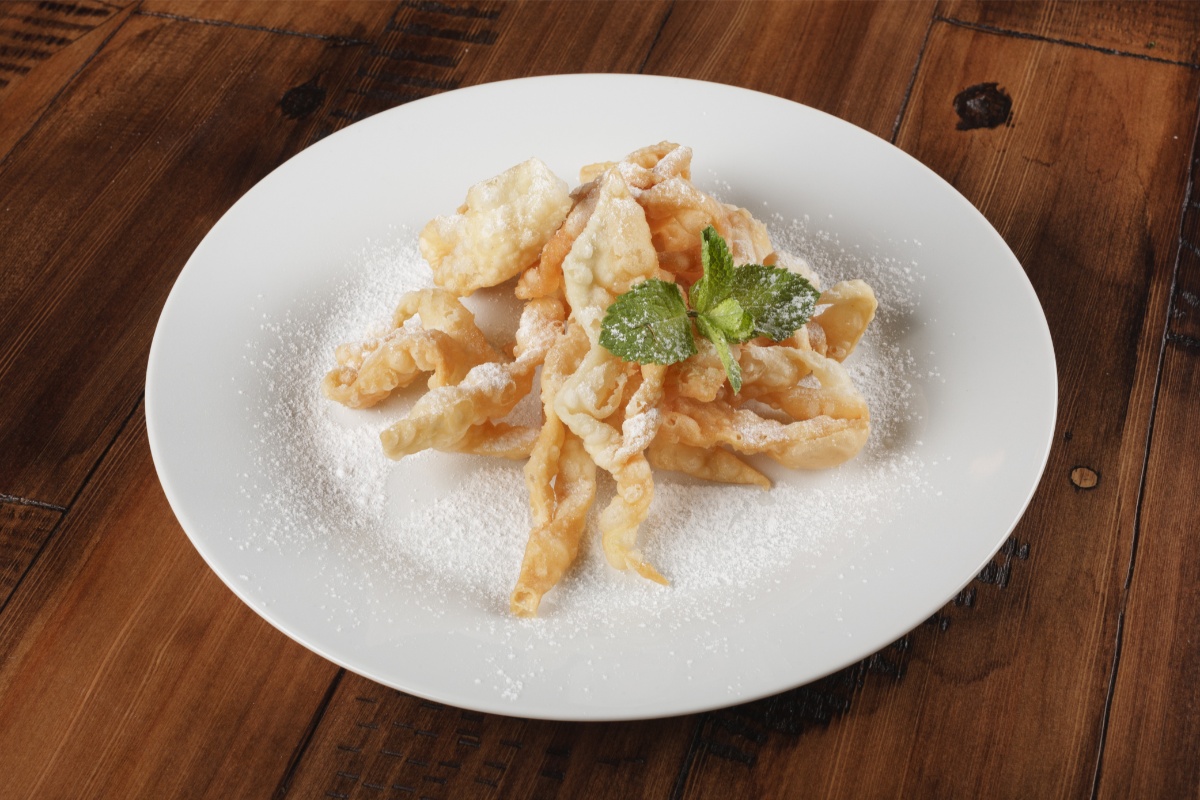 A plate of Žagarėliai (Angel Wings) on a table | Girl Meets Food