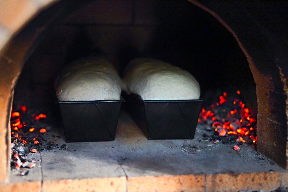 Handmade breads being cooked in a traditional bread oven | Girl Meets Food