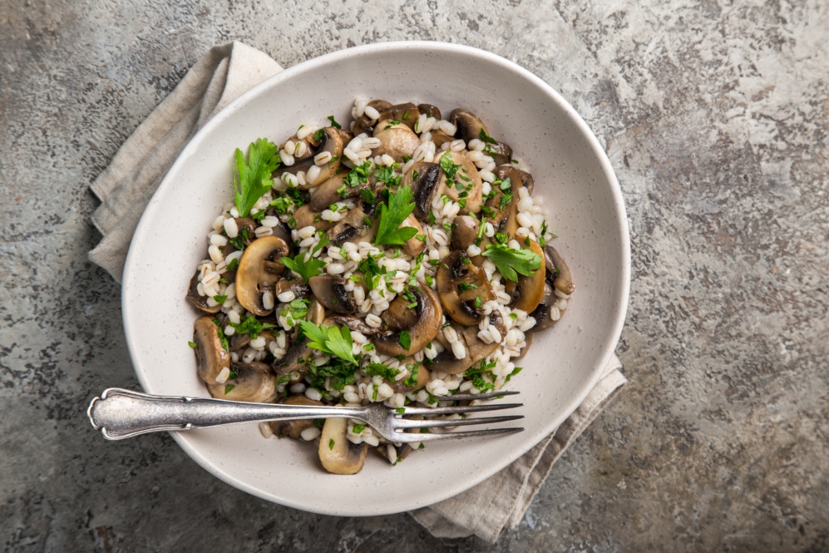 A bowl of Houbový Kuba (Mushroom Barley) on a marble surface | Girl Meets Food