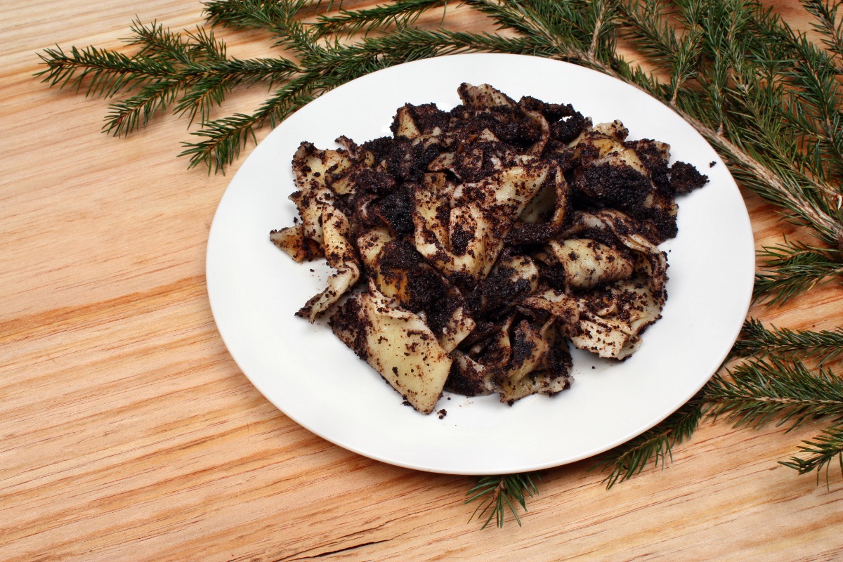 A plate of Nudle s Makem (Noodles with Poppy Seeds) and Christmas tree branch on a table | Girl Meets Food